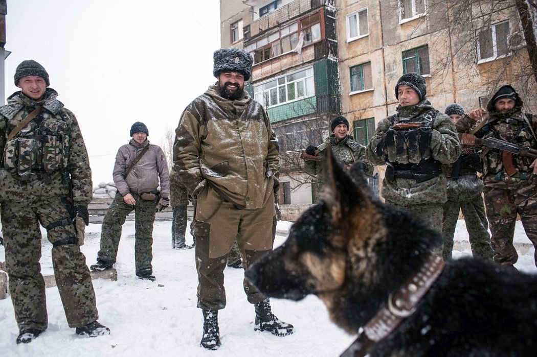 UKRAINE. Shahanov, East Ukraine. November 30, 2014. Cossack separatists at the front line with German shepherd patrol dog.